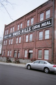 Wafco Mills building with sign painted on the brick wall: Feed Flour WAFCO MILLS Corn Meal