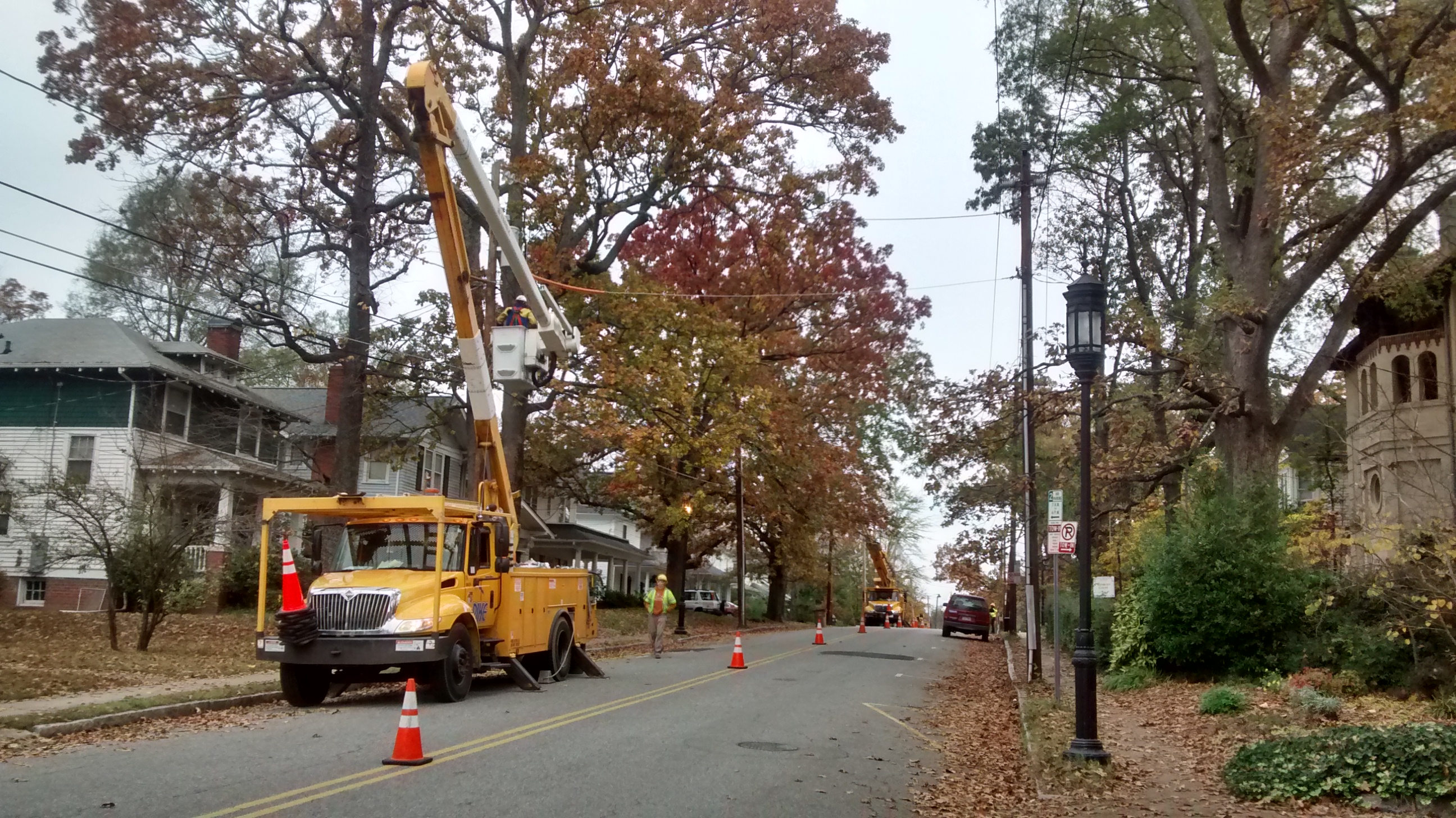 Two crews of workers install new streetlights