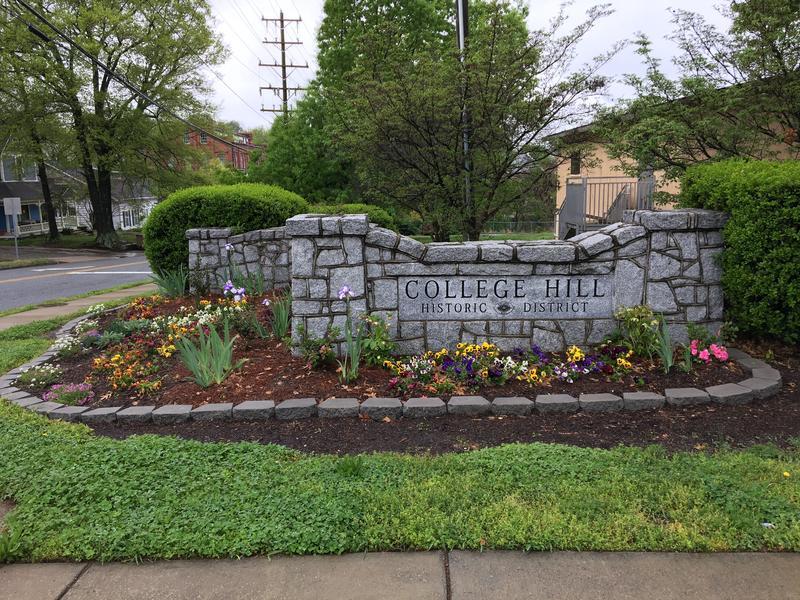 College Hill sign with well-tended flower bed